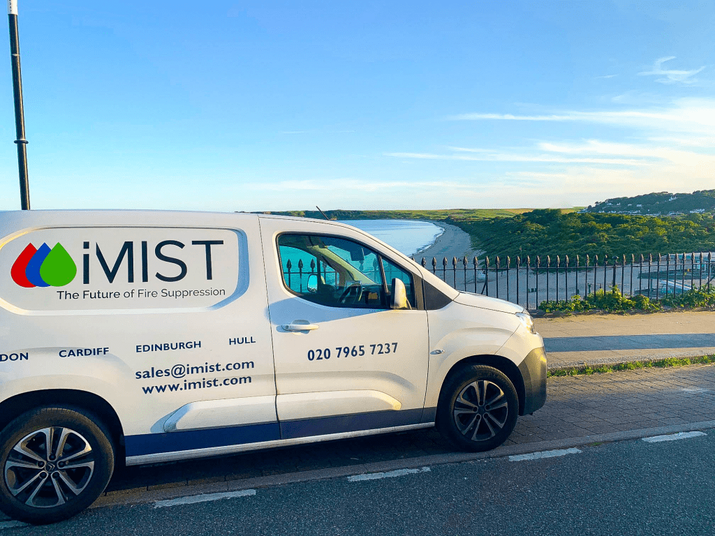 iMist van in wales driving around with beautiful beach backdrop